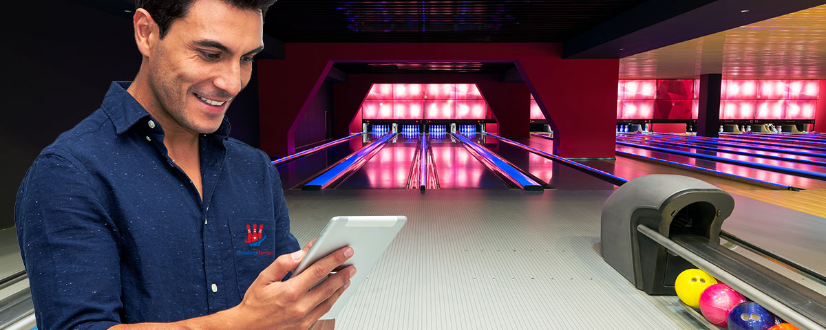 A bowling alley owner checks news on his tablet