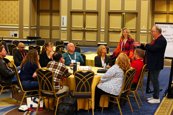 A photo a lively roundtable discussion group at AEI 2024