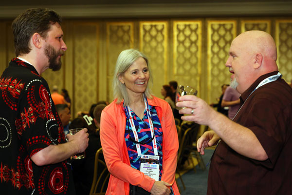 A photo of attendees chatting at AEI 2024